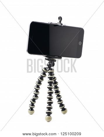 Smartphone set up on a tripod isolated over the white background