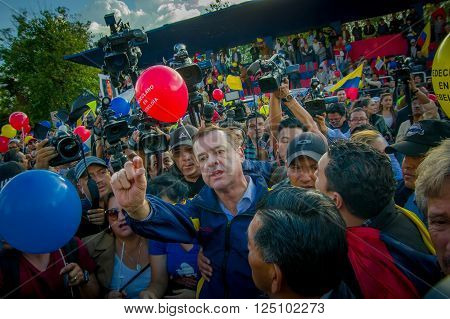 Quito, Ecuador - April 7, 2016: Closeup opposition leader Andres Paez surrounded by people, police and journalists during anti government protests in Shyris Avenue.