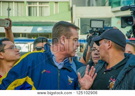 Quito, Ecuador - April 7, 2016: Closeup opposition leader Andres Paez surrounded by people, police and journalists during anti government protests in Shyris Avenue.