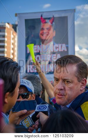 Quito, Ecuador - April 7, 2016: Closeup opposition leader Andres Paez surrounded by people, police and journalists during anti government protests in Shyris Avenue.