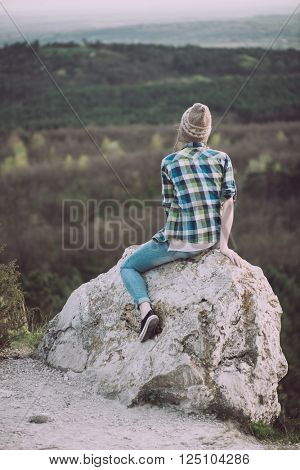 Young woman watching landscape, posing outdoor. Active lifestyle concept. 