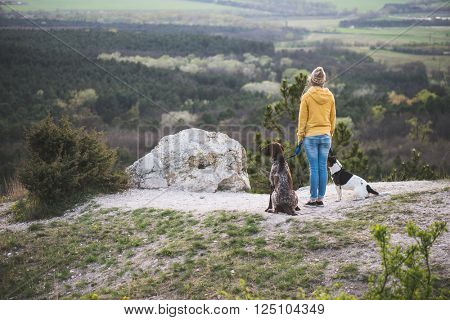 Woman and her dogs posing outdoor. 