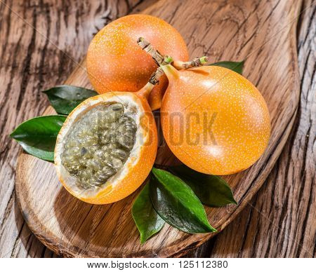 Granadilla fruits on the wooden table.