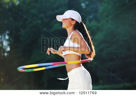 woman rotates hula hoop