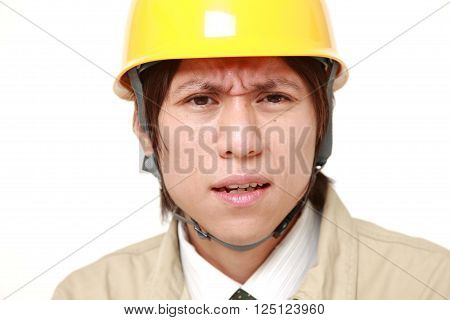 portrait of perplexed construction worker on white background