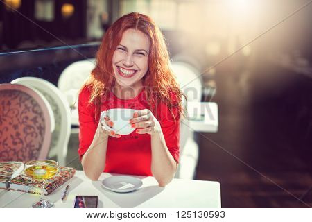 Girl portrait with cup of coffee, girl in the interior.