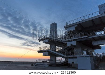 Modern architechture building on sea sunset sky background