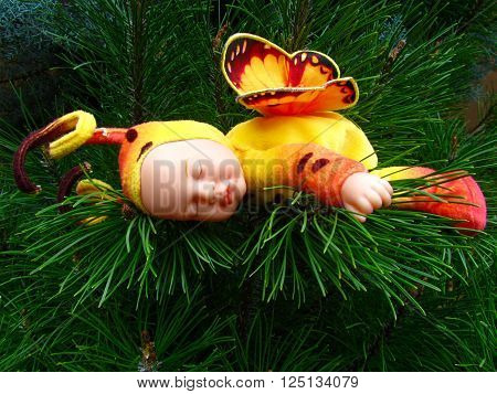 Sleeping butterfly fairy in a pine tree