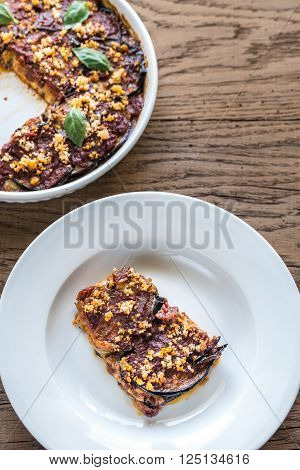 Dish and portion of Parmigiana di melanzane: top view