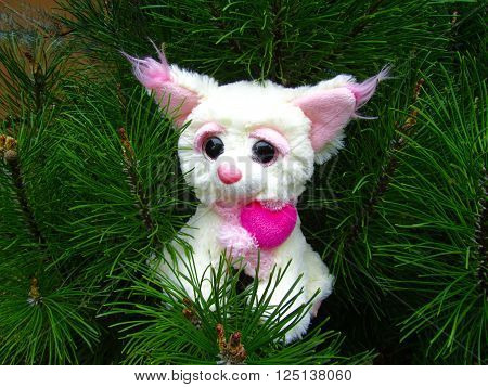 White plush fox toy on the pine tree