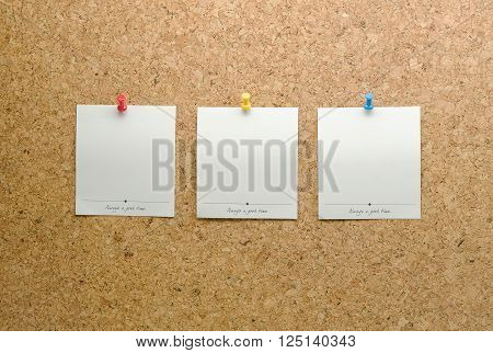 Paper cards posted on a cork board with tack pin