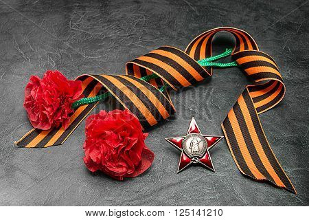 George ribbon order of red star and self-made carnations. Postcard to the Day of Victory. May 9/ Russian translation: proletarians of all countries unite! The USSR