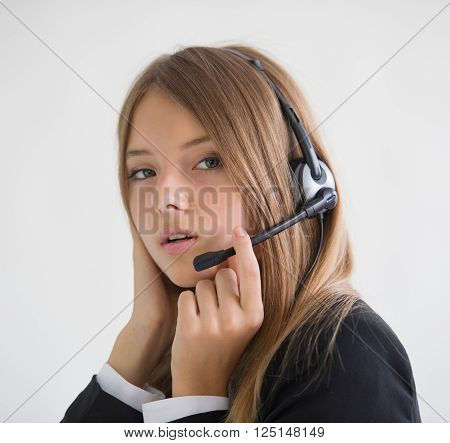 girl secretary talking on the speakerphone on light background