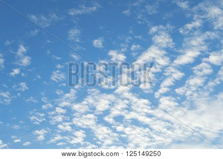 Sign of good weather high Cumulus or Altocumulus clouds in deep blue spring sky