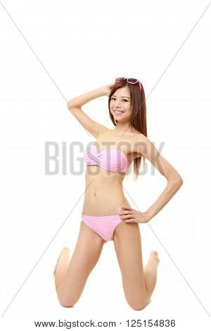 Japanese woman posing in a pink bikini