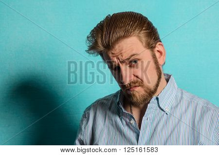 displeased rockabilly man vintage fifties style on blue background