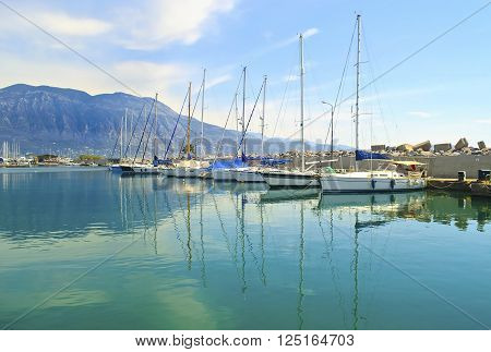 sailboats reflected on sea at Kalamata harbor Peloponnese Greece