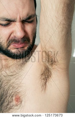 funny man having bad smell from armpit