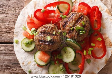 Meatballs with fresh vegetables and Flatbread close-up. Horizontal top view