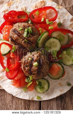 Meatballs with fresh vegetables and Flatbread close-up. vertical top view