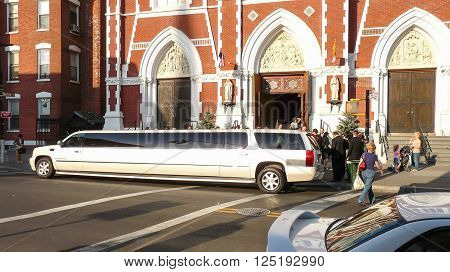Brooklyn New York - April 18 2008: Stretch white limo waiting for newlyweds before Saint Anthony Church at Greenpoint