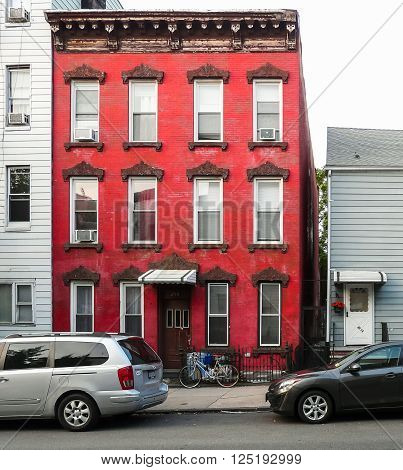 Brooklyn New York - August 16 2014: Red front of old brick house at Manhattan Ave in Greenpoint.