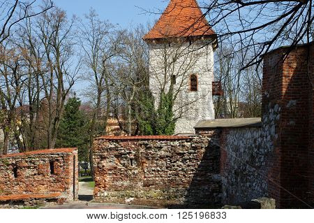 Wieliczka, Poland - April 04, 2016: Saltworks Castle. Fragment of the defensive walls of the fifteenth century. In the middle stands the tower of the fourteenth century.
