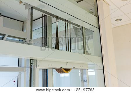 Pulley with several steel cables is just one detail in new elevator.