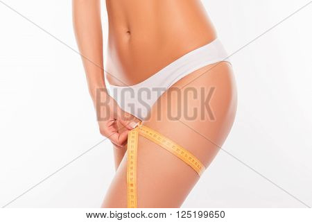 Close Up Photo Of Woman Measuring Her Leg's Size With Tape Measure