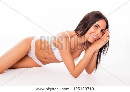 Smiling Healthy Slim Woman Lying In White Lingerie