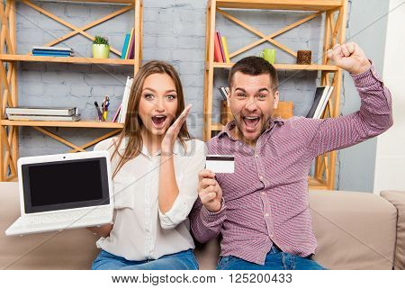 Happy Man And Woman Screaming With Laptop And Bank Card