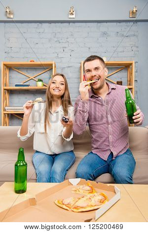 Excited Young Couple Watching Film With Beer And Pizza