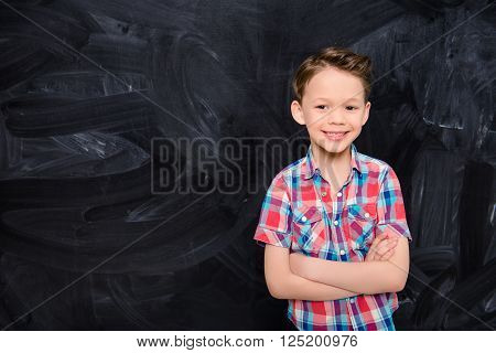 Portrat Of Happy Smiling Little Boy With Crossed Hands