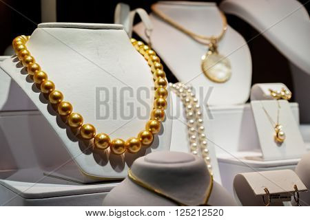 Waikiki, Honolulu, Hawaii, USA - December 14, 2015: Pear jewelries on public display in the evening at Na Hoku, along Kalakaua Avenue. It features the central golden pearl necklace.

Na Hoku is a long-standing retail chain designing and manufacturing a 