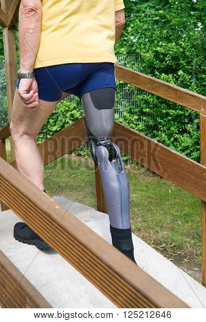 Unidentifiable Man Going Over Ramp With False Leg At Exercise Course.