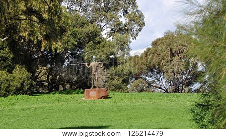 PERTH,WA,AUSTRALIA-AUGUST 10,2013: Yagan statue of aboriginal warrior at Heirisson Island in nature setting in Perth, Western Australia.