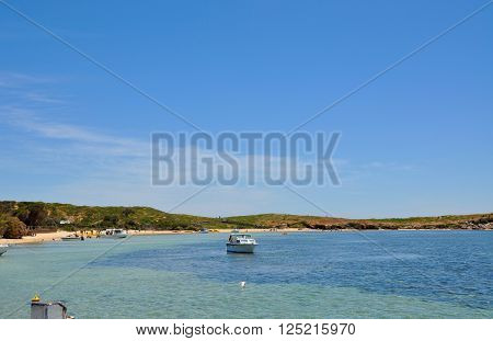 ROCKINGHAM,WA,AUSTRALIA-NOVEMBER 8,2013: Boating recreation,people and vegetated dunes with the Indian Ocean waters at Penguin Island in Rockingham, Western Australia.