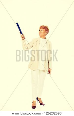 Smile elderly woman pointing up with hege pen