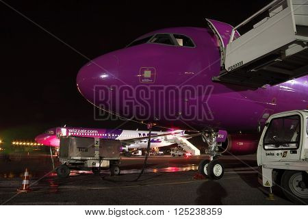 Kiev Ukraine - March 27 2011: Wizz Air Airbus A320 passenger planes being serviced at the airport at night