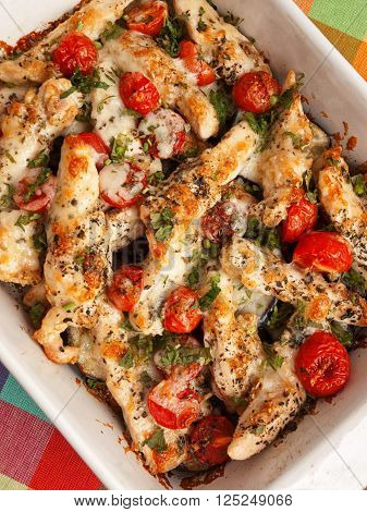 Italian chicken bake casserole with mozzarella cherry tomatoes and oregano shot from above
