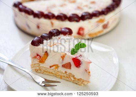 Cake with strawberries gelly yogurt and cherries isolated on white background in a plate
** Note: Shallow depth of field