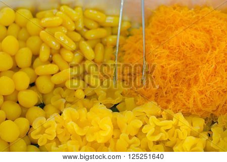 Sweet egg floss and egg yoke fudge balls (Other names are Fios de Ovos Angel's hair egg's threads sweet golden drops) cooked in syrup