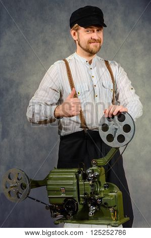 cheerful projectionist with a old film projector