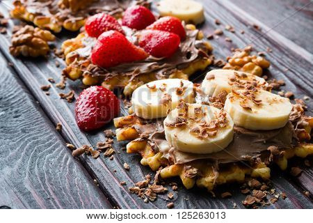 waffles with chocolate paste strawberries bananas sprinkled with chocolate