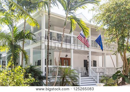 American Flag on White Wood House with Two Verandas in Key West