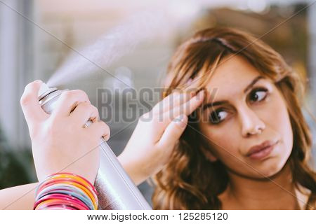 Spraying hair with hairspray, horizontal image , selective focus