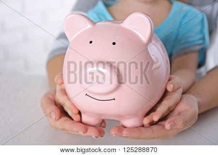 Savings concept. Hands holding piggy bank, close up - Stock Image ...