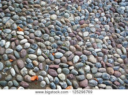 Closeup of old street gravel pavement texture