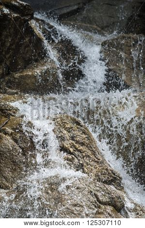 Water cascades over rocks on Vermont hillside near Lake Willoughby