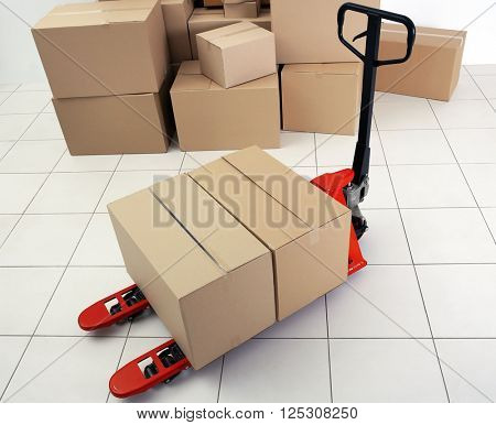 Manual pallet truck with carton boxes indoors